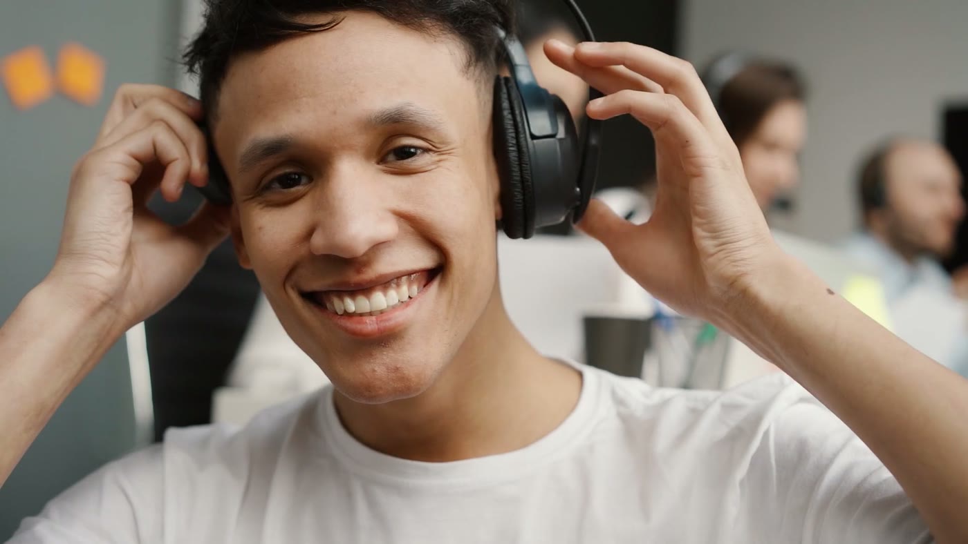 An agent wearing a headset, talking with a customer